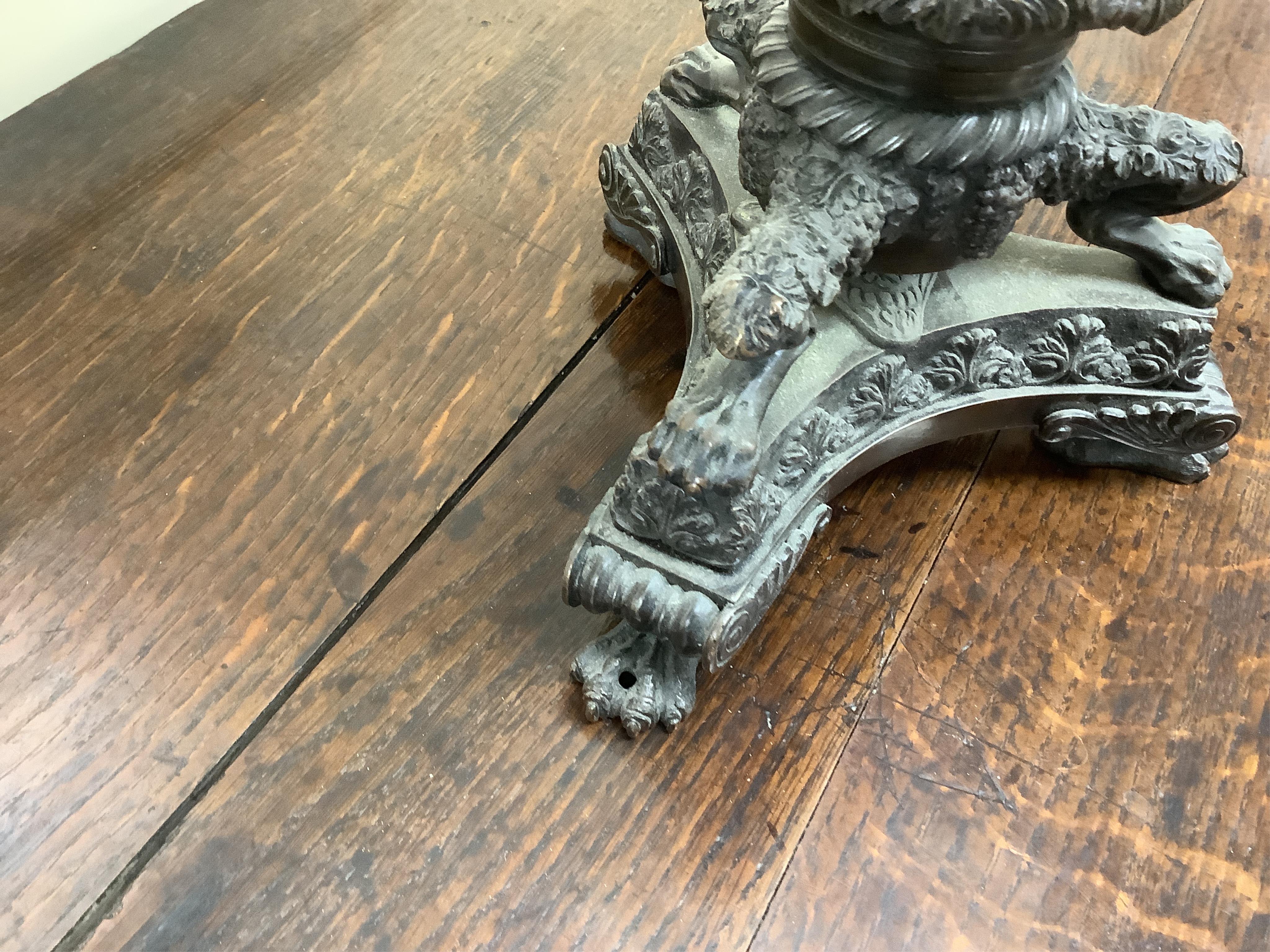 A large cut glass tazza, on bronze tri-form pedestal base, 39cm high.